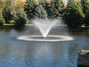 Scott Aerator Solar Display Fountain with pine trees in background